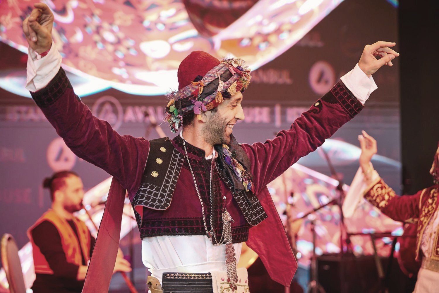 A performer in traditional dress dancing on stage